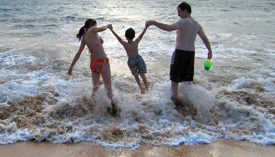 vacation rentals oc family playing in the ocean